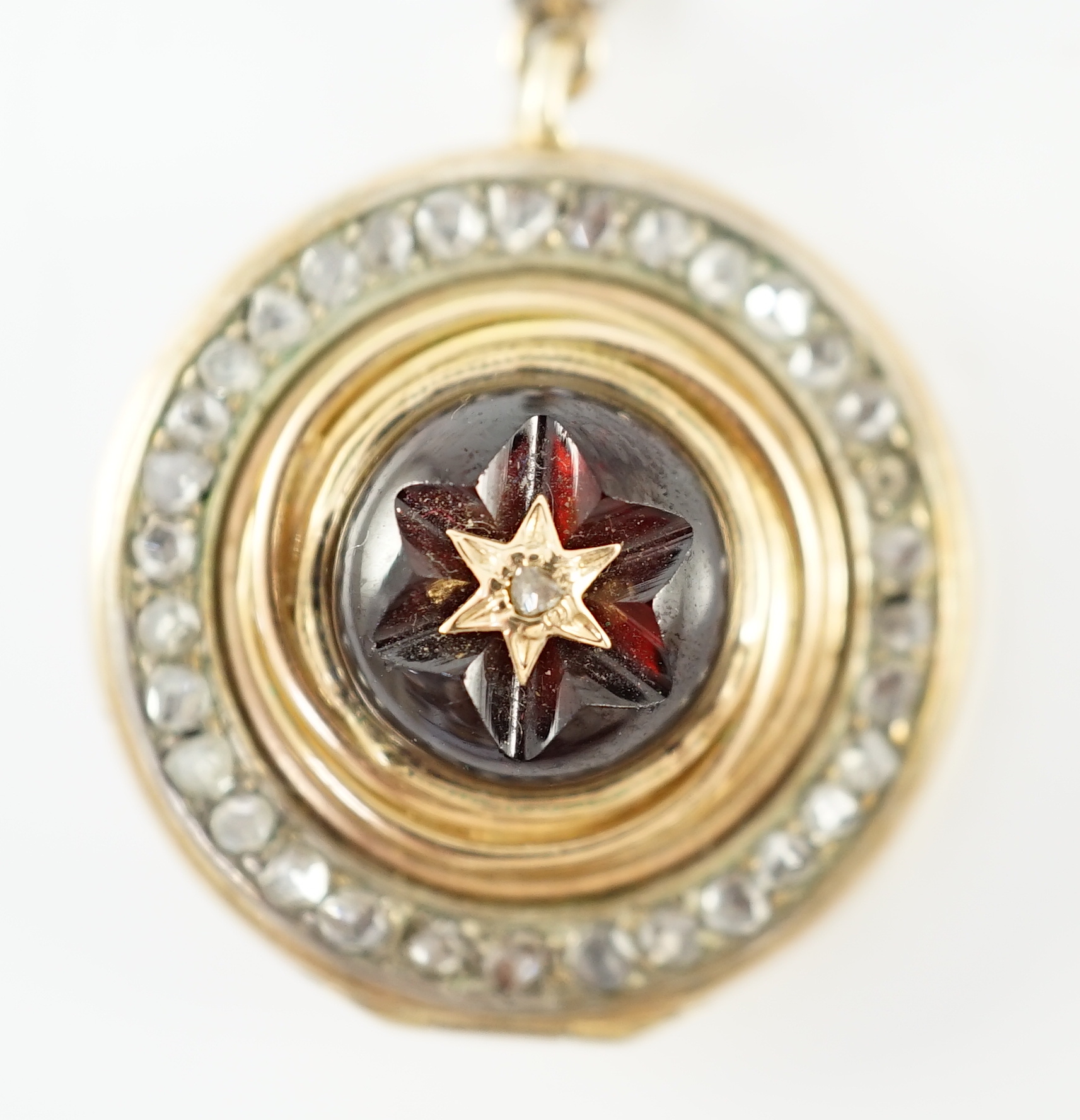 A 19th century gold, cabochon garnet and rose cut diamond set cluster target pendant